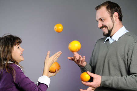 man and girl playing with fruitsの写真素材