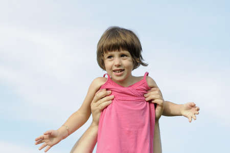 happy child posing against blue skyの写真素材