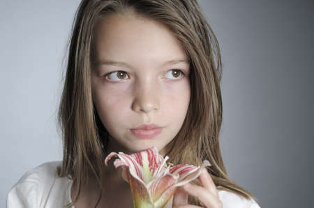 beautiful girl admiring lily flowerの写真素材