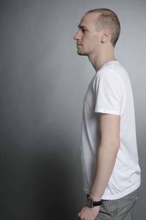 young man posing with clockの写真素材