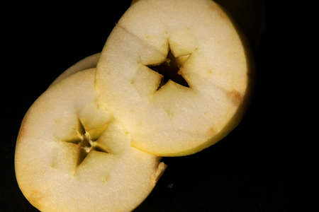 sliced apple isolated on black backgroundの写真素材