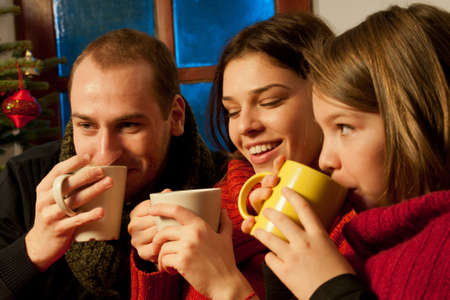 happy young people drinking and celebrating christmasの写真素材