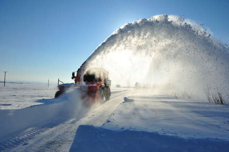 snow blower cleaning road in winter seasonの写真素材