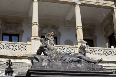 stone neptun statue against historical columnsのeditorial素材