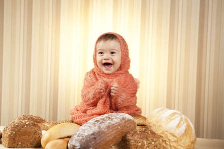 smiling kid playing with breadの写真素材