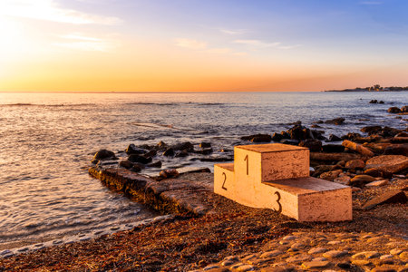 amazing morning view on a sunrise in sea with old competition podium with top places for water sport in seaの写真素材