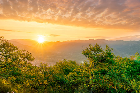 graet highland landscape with scenic view from mountain to below to a walley with majectic mountains and scenic cloudy sunset on backgroundの写真素材