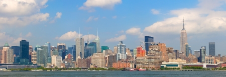 New York City, USA colorful skyline panorama with landmark buildings in downtown business and residential districts with blue sky の写真素材