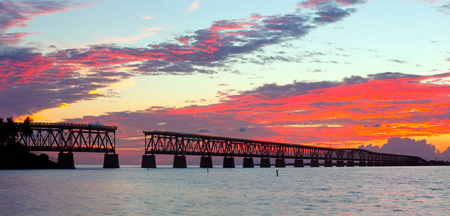 Colorful landscape of a beautiful tropical sunset or sunrise. Taken at Bahia Honda Key State Park in Florida. Old Flagler Bridge remains as a tourist landmark and a monument to a hurricane. の写真素材
