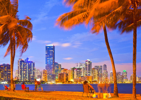 MIAMI FLORIDA, USA-OCTOBER 5, 2013:  Night skyline and people fishing in Miami Floridaのeditorial素材
