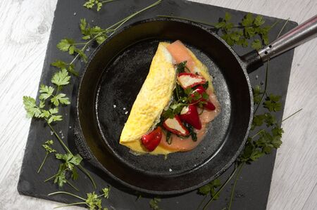 Pepperoni cream with spinach and smoked salmon on a slate and white wood backgroundの写真素材