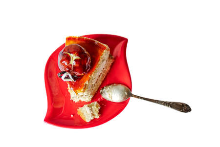 Delicious piece of cake on red saucer, isolated white background with clipping pathの写真素材