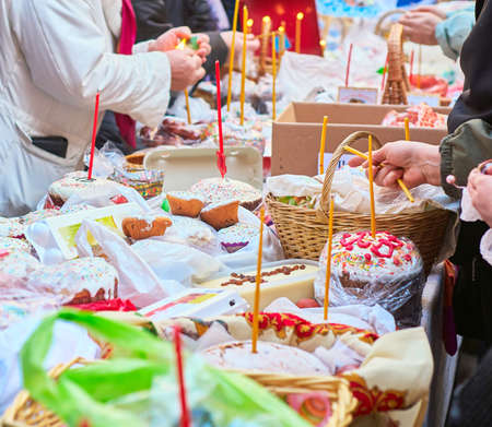 People come to church consecrate Easter cakes and eggs, lit church candles, inserted into the cakes