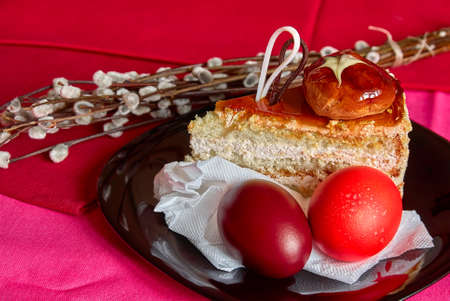 Festive Easter table with eggs, cake and willow twigsの写真素材