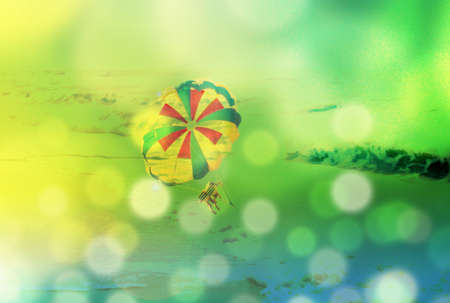 Summer blur background with parachute and sunshine, sea vacation, tinted photo collageの写真素材