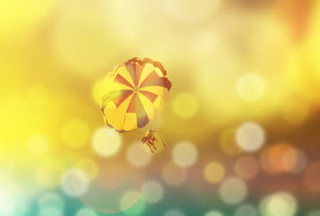 Summer blur background with parachute and sunshine, sea vacation, tinted photo collageの写真素材