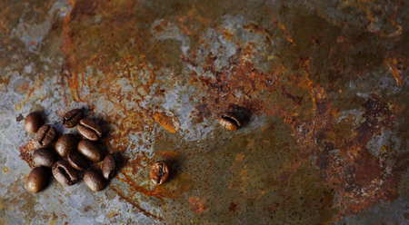 Fried coffee beans on old metallic surface, vintage coffee background