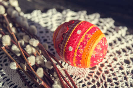 Easter postcard with handmade souvenir egg and blooming pussy willow close upの写真素材