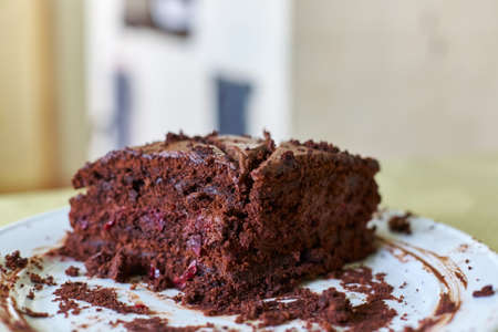 Pieces homemade truffle-cranberry cake with chocolate cream on table closeupの写真素材