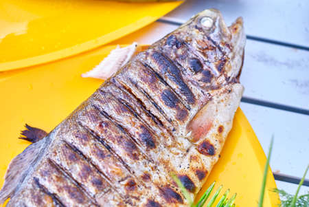 Fried fish grill on the table close upの写真素材