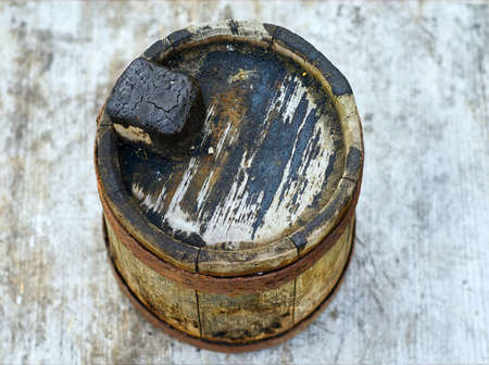 Old wooden smudgy barrel for fuel oil closeup