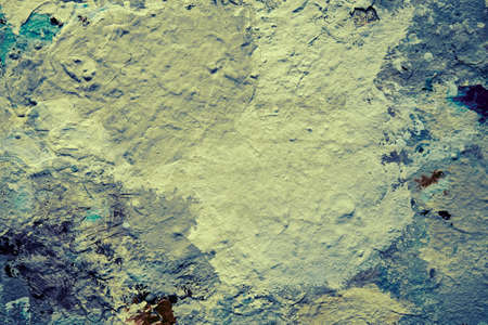 Dirty artist palette with dried paint close up