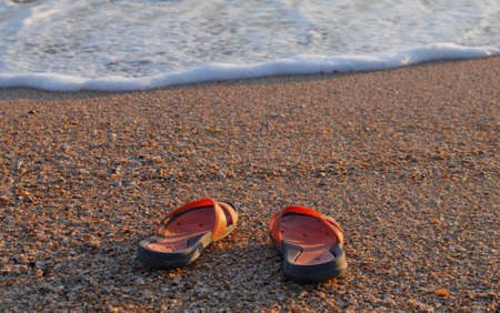 Beach flip flops on sea sand closeupの写真素材