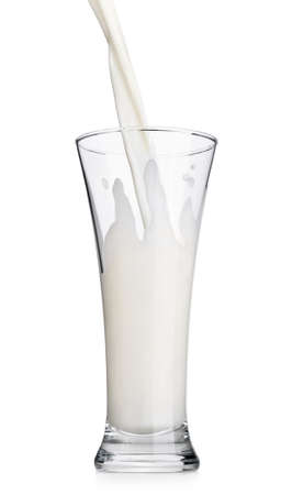 Pouring milk in a glass isolated on white backgroundの写真素材