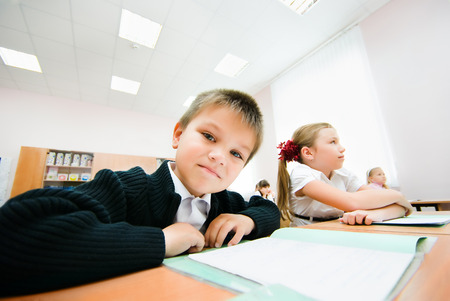 Small children sit in desksの写真素材