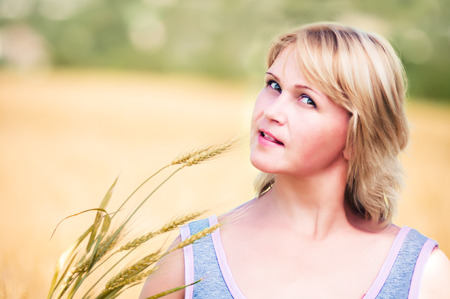 Portrait of a woman in wheat fieldの写真素材