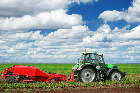 Agricultural machinery for planting and harvesting vegetables on fieldの写真素材