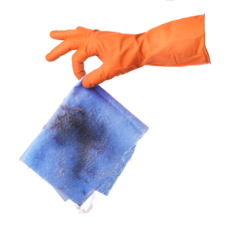 Hand with orange rubber glove holds blue ditry cloth isolated on white backgroundの写真素材