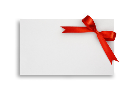 Red silk bow on empty paper card isolated on white backgroundの写真素材
