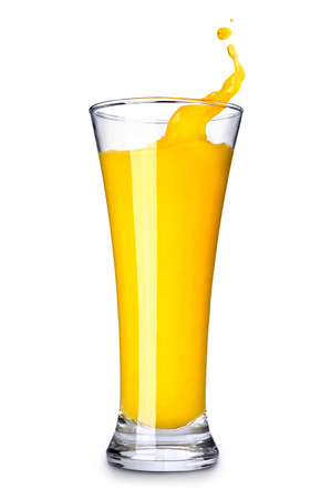 Splashing orange juice in glass on white backgroundの写真素材