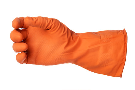 Hand with orange rubber glove holds something isolated on white backgroundの写真素材