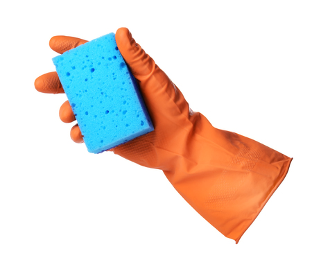 Hand with orange rubber glove holds blue sponge isolated on white backgroundの写真素材