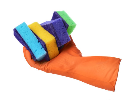 Hand with orange rubber glove holds sponges isolated on white backgroundの写真素材