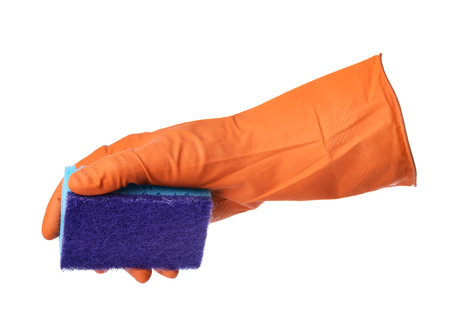 Hand with orange rubber glove holds blue sponge isolated on white backgroundの写真素材