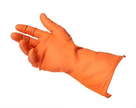 Hand with orange rubber glove holds something isolated on white backgroundの写真素材
