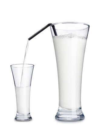 Milk is poured from one big cup to anotherの写真素材