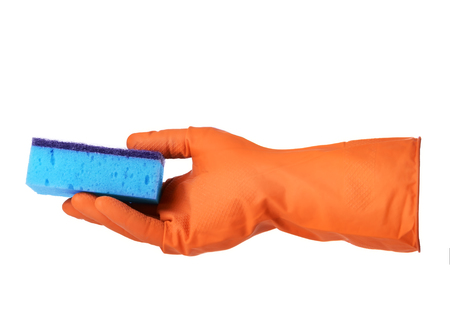 Hand with orange rubber glove holds blue sponge isolated on white backgroundの写真素材