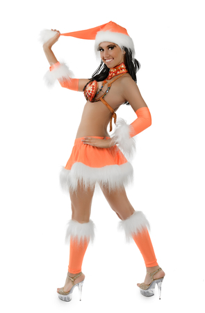 Cute sexy girl in orange christmas costume isolated on white backgroundの写真素材