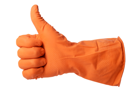 Thumbs up with a orange rubber glove isolated on white backgroundの写真素材