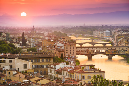 Colorful sunset over Ponte Vecchio on Arno River, Florence, Italyの写真素材
