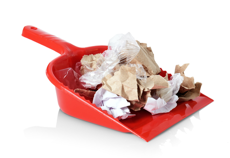 Red shovel with litter isolated on white backgroundの写真素材