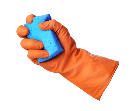 Hand with orange rubber glove holds blue sponge isolated on white backgroundの写真素材
