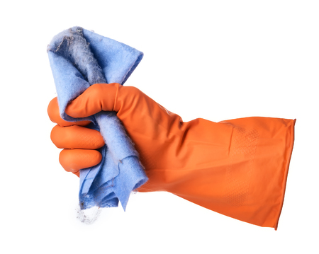 Hand with orange rubber glove holds blue ditry cloth isolated on white backgroundの写真素材