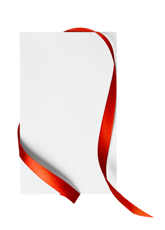Red silk ribbon on empty paper cardの写真素材