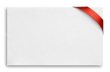 Red silk ribbon on empty paper cardの写真素材
