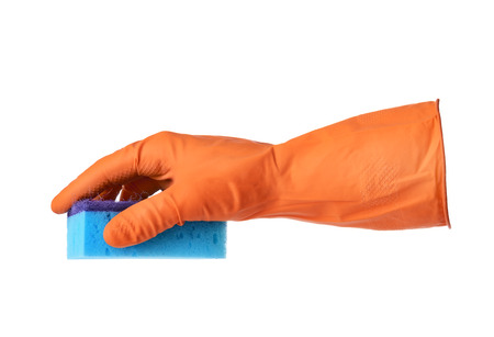 Hand with orange rubber glove holds blue sponge isolated on white backgroundの写真素材